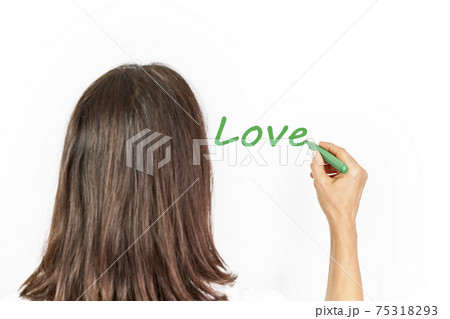 Woman writing the word Love on a white background with a green marker Woman writing the word Love on a white background with a green marker 75318293