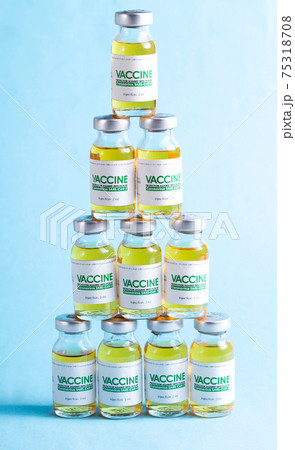 Vials of coronavirus vaccine doses are arranged in a pyramid on a blue background. Vaccine research and development concept covid-19, Vials of coronavirus vaccine doses are arranged in a pyramid on a blue background. Vaccine research and development concept covid-19, 75318708