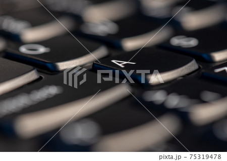 Macro shot of black keyboard focus on A key Macro shot of black keyboard focus on A key 75319478