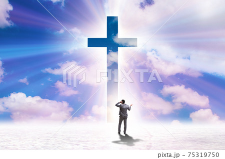 Religious concept with cross and lonely man Religious concept with cross and lonely man 75319750