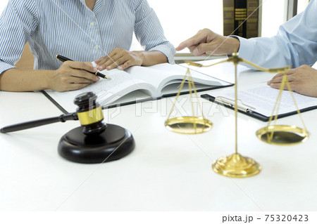 Lawyers and assistants are discussing legal matters to prepare contracts Lawyers and assistants are discussing legal matters to prepare contracts 75320423