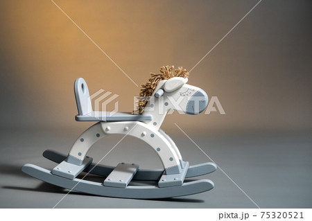 Handmade rocking horse on a gray background Handmade rocking horse on a gray background 75320521