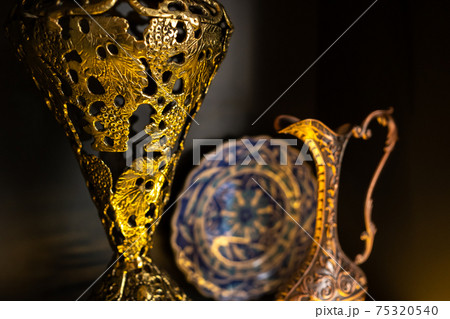 Old copper jug from the east on a black background 75320540