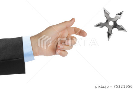 Hand is throwing ninja shuriken 75321956