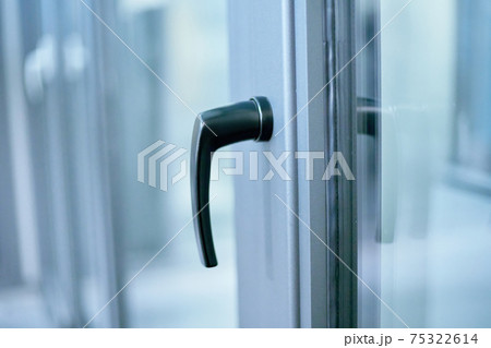 stylish metal handle on the window frame. 75322614