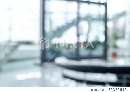 blurry image. large window and a staircase in an office building . 75322615