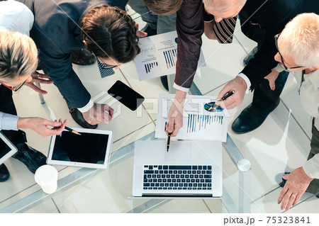 business colleagues using a laptop to work with financial statistics. business colleagues using a laptop to work with financial statistics. 75323841