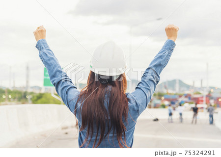 Woman engineer entrepreneur construction industry worker. Female engineer working refinery oil plant manufacturing. Young civil engineering construction wear hard hat safety helmet construction site. 75324291