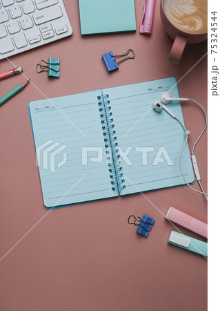 Above view of empty notebook and stationery on pink pastel background. 75324544