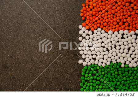 Kalu or tiny balls of sugar syrup with sesame seeds inside for Sankranti festival in Maharashtra 75324752