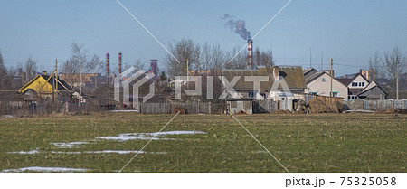 village house on the background of an industrial factory. 75325058