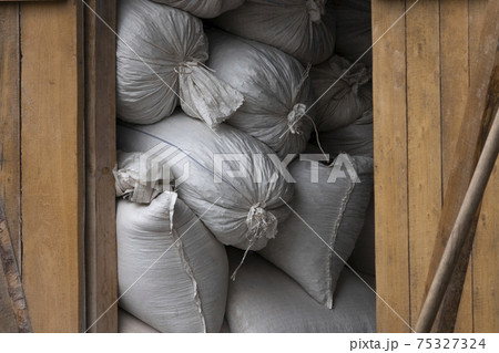 large bales of straw lie under a canopy from the rain large bales of straw lie under a canopy from the rain 75327324