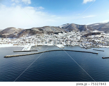 早春の北海道豊浦町豊浦漁港の雪景色を空撮 75327843