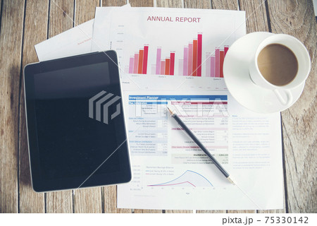 Office laptop business financial document chart and graph on wooden table with coffee cup. Flat lay notebook computer laptop on office desk. No people business graph chart mockup on business workspace Office laptop business financial document chart and graph on wooden table with coffee cup. Flat lay notebook computer laptop on office desk. No people business graph chart mockup on business workspace 75330142