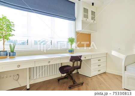 Interior, white furniture, table and chair near the window, cork board on wall Interior, white furniture, table and chair near the window, cork board on wall 75330813