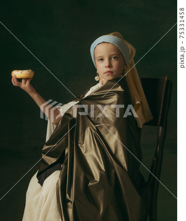 Medieval little girl as a lady with a pearl earring on dark studio background. Concept of comparison of eras, childhood. Stylish creative design, art vision, new look of artwork. Medieval little girl as a lady with a pearl earring on dark studio background. Concept of comparison of eras, childhood. Stylish creative design, art vision, new look of artwork. 75331458