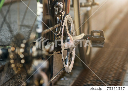 Detailed view of bicycle mechanisms. Sprocket, pedal and chain on a mountain bike Detailed view of bicycle mechanisms. Sprocket, pedal and chain on a mountain bike 75331537