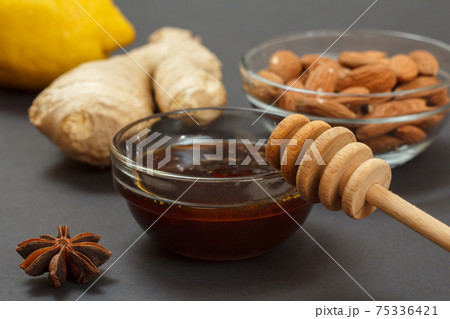 Health remedy foods for cold and flu relief on a black background. Health remedy foods for cold and flu relief on a black background. 75336421