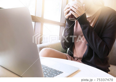Woman working in cafe wearing protective mask. coronavirus COVID-19 Social distancing keep distance in public society people to protect COVID-19 75337470