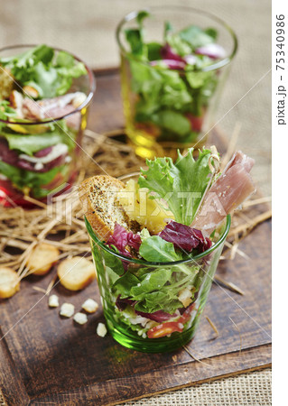 fresh salad with ham in glass bowl 75340986