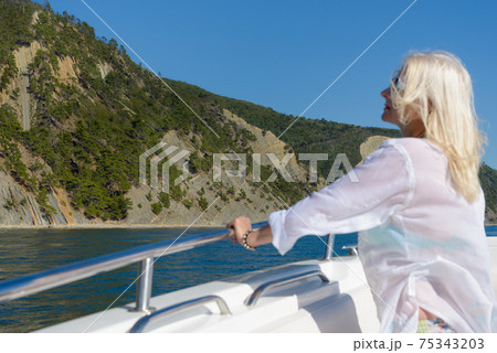 Blonde poses on a white yacht Blonde poses on a white yacht 75343203
