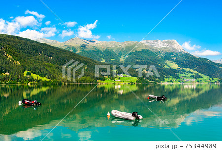 Boats on Reschensee, an artificial lake in the Italian Alps 75344989