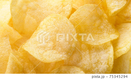 Yellow salted potato chips as background. Chips texture Yellow salted potato chips as background. Chips texture 75345294