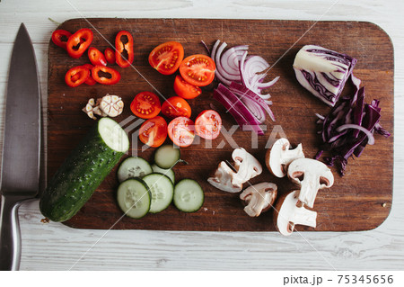 Chopped vegetables and mushrooms on cutting board Chopped vegetables and mushrooms on cutting board 75345656