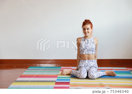 sporty young attractive caucasian woman in black and white sportswear practicing or exercise yoga indoor. balance between body and mental. (healthy life concept) 75346340
