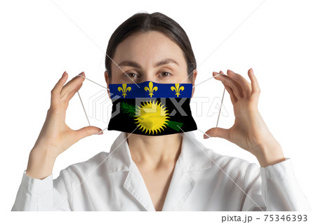 Respirator with flag of Guadeloupe Doctor puts on medical face mask isolated on white background 75346393