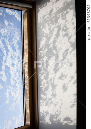 Shadow on the wall from the snow on the window 75348706