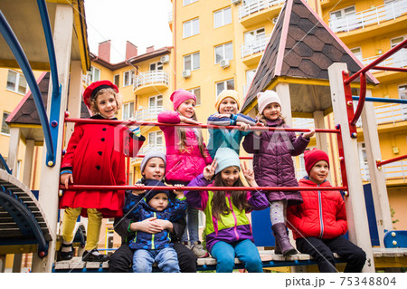 Cheerful kids at outdoor playground in early spring 75348804