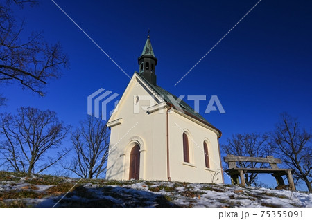 Beautiful winter landscape with church. Sunny winter day. Brno - Lisen. Chapel of Our Lady of Helper. 75355091