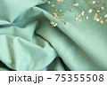 Beautiful folds of green natural fabric background with shadows 75355508