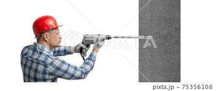 worker handyman or builder worked with construction tools - electric drill 75356108