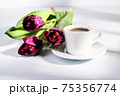 cup of blakc coffee and purple tulips 75356774