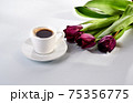 cup of blakc coffee and purple tulips 75356775