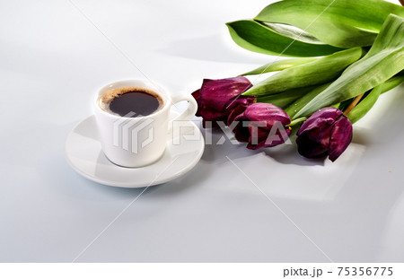 cup of blakc coffee and purple tulips cup of blakc coffee and purple tulips 75356775