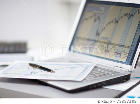 Businessman analyzing investment charts with laptop. Accounting 75357285