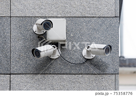 Security cameras on modern building. Professional surveillance camera. CCTV on the wall with LED IR lights. Security system, technology concept. Video equipment for safety system area control outdoor. Security cameras on modern building. Professional surveillance camera. CCTV on the wall with LED IR lights. Security system, technology concept. Video equipment for safety system area control outdoor. 75358776