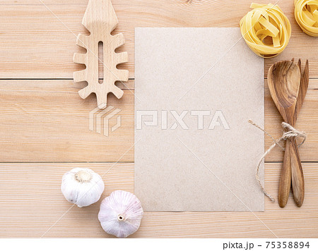 Italian foods concept and menu design . Blank paper and  pasta ladle on wooden background. 75358894