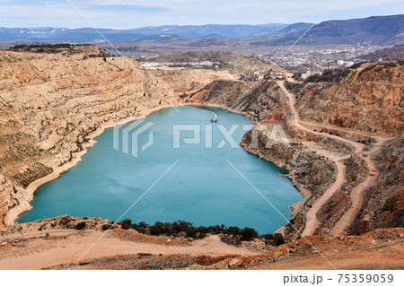 the opened blue heart of the earth - abandoned quarry with a heart-shaped lake at the bottom 75359059
