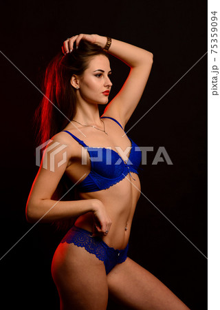Sexy fashion brunette woman with long dark hair in blue lingerie, isolated on dark gray background Sexy fashion brunette woman with long dark hair in blue lingerie, isolated on dark gray background 75359094