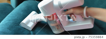 Use small vacuum cleaner to clean fabric on sofa. Use small vacuum cleaner to clean fabric on sofa. 75359864