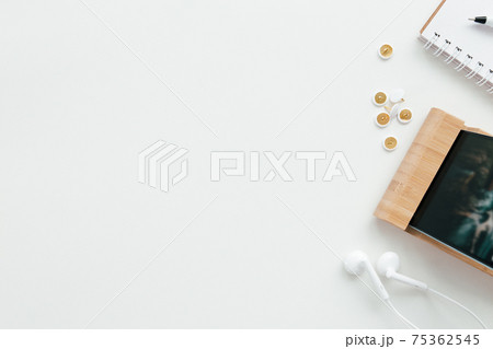 Office work, education flat lay concept with phone, headphones, white background Office work, education flat lay concept with phone, headphones, white background 75362545