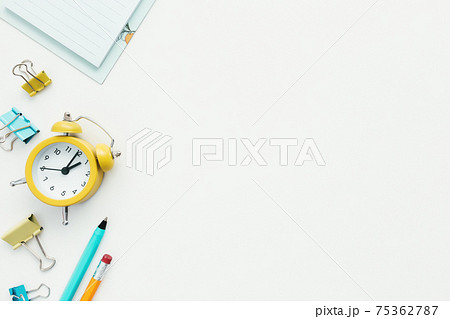 Paper clips, clock, pen, pencil on white background. Work and education concept Paper clips, clock, pen, pencil on white background. Work and education concept 75362787