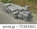Pile of gray paving slabs stacked on the roadside 75363801