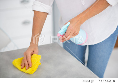 Close up picture of a woman disinfecting the surfaces Close up picture of a woman disinfecting the surfaces 75366010