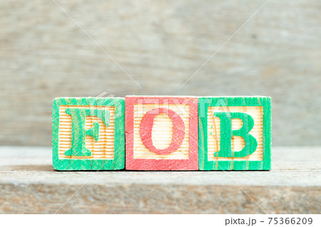 Color alphabet letter block in word FOB (Abbreviation of Free on Board) on wood background 75366209
