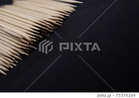 bamboo created toothpick on black background bamboo created toothpick on black background 75370284